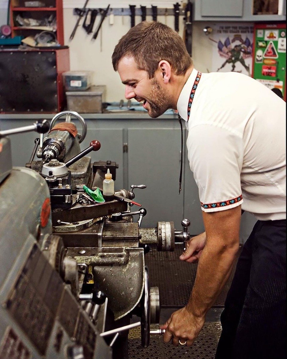 In his garage shop with the lathe they describe as "their baby." 