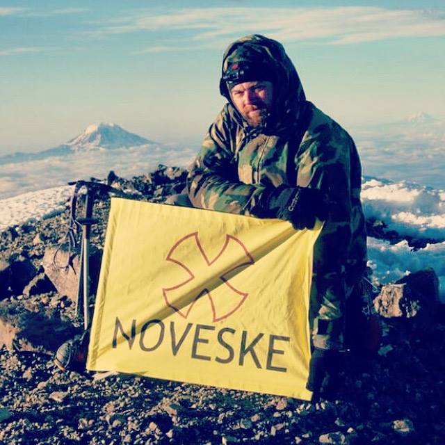 Mountain climbing and posting the Noveske Arms banner. 